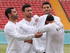 Egypt's forward Mohamed Salah, right, is helped by teammates during a training session in Grozny on Saturday.