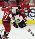 Carolina Hurricanes' Valentin Zykov checks the Senators' Fredrik Claesson . AP Photo/Gerry Broome