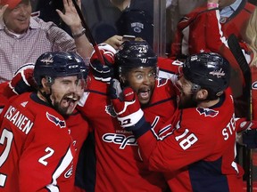 Capitals forward Devante Smith-Pelly, centre, celebrates his third-period goal against the Golden Knights with Matt Niskanen, left, and Chandler Stephenson.