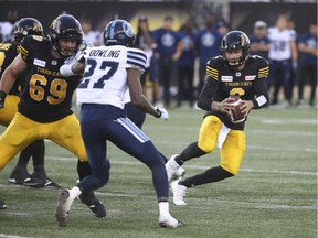 Tiger-Cats QB Johnny Manziel scrambles  during the second quarter of Friday's pre-season CFL action against the Argonauts. Jack Boland/Postmedia