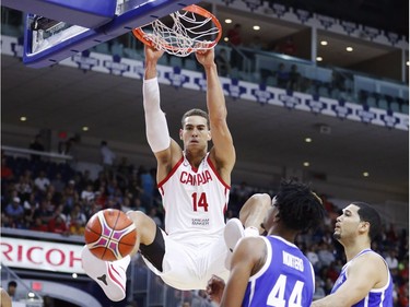 Canada's Dwight Powell dunks the ball for two points in Friday's game against the Dominican Republic.