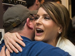 Amanda Simard receives a hug from a supporter after arriving at her campaign headquarters after winning Glengarry-Prescott-Russell on Thursday night. Wayne Cuddington/Postmedia