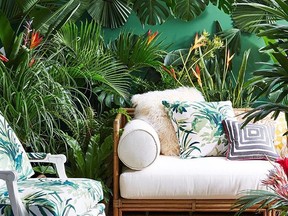 Palm tree and general foliage patterns used for these cushions and the upholstered chair are a fitting choice for outdoor use.