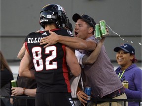 Ottawa Redblacks' Greg Ellingson (82) is hugged by fans after making a conversion during first half CFL action against the Saskatchewan Roughriders in Ottawa on Thursday, June 21, 2018.