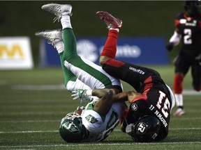 Redblacks linebacker Kevin Brown (31) brings down Roughriders receiver Spencer Moore during the first half of Thursday's game at TD Place stadium.