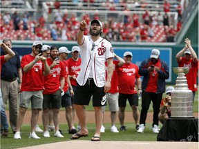 Capitals captain Alex Ovechkin playfully asks to throw out a second ceremonial first pitch before Saturday's game between the Washington Nationals and the San Francisco Giants. His first attempt had sailed high over the catcher's head.