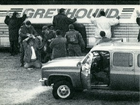 OTTAWA, April 7--Police close in on a Greyhound bus that was the scene of a hostage taking on Parliament Hill in 1989. Police are shown handcuffing a man on his knees while others are with hands up on the bus.