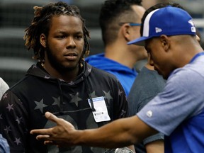 Toronto Blue Jays prospect Vladimir Guerrero Jr., left, listens to left fielder Curtis Granderson before a baseball game against the Tampa Bay Rays Monday, June 11, 2018, in St. Petersburg, Fla.