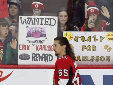 Fans hold up signs in support of Ottawa Senators captain Erik Karlsson (65) during the warm-up before NHL hockey action against the Winnipeg Jets at the Canadian Tire Centre in Ottawa on Monday, April 2, 2018.