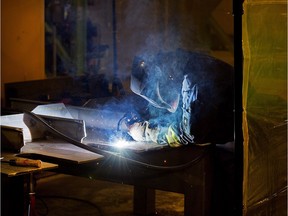 The file photo shows Irving workers constructing components of the Arctic offshore patrol ships at the Irving shipbuilding facility.