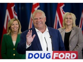 Ontario PC leader Doug Ford announces that his party will always respect veterans, soldiers and police during a press conference at the London Convention Centre in London, Ont. on Thursday May 31, 2018. He is flanked by Newmarket-Aurora candidate Christine Elliott (left) and London-North-Centre candidate Susan Truppe. Derek Ruttan/The London Free Press/Postmedia Network