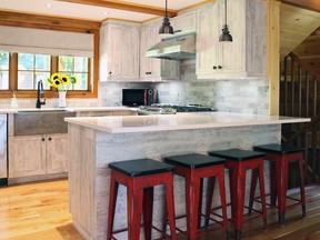Laminate kitchen cabinetry has the look of weathered wood and complements the rustic feel of a chalet in the Laurentians.