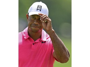 Tiger Woods tips his cap to the fans on the 17th hole during the third round of the Memorial golf tournament Saturday, June 2, 2018, in Dublin, Ohio.
