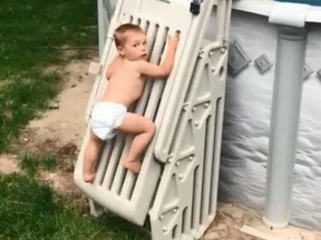 In a viral video, 2-year-old Cody Wyman scales a previously un-climbable pool ladder. (Facebook)