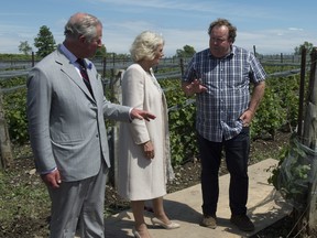 Prince Charles and Camilla Duchess of Cornwall speak with Norman Hardie as they visit his winery in Wellington, Ont. Friday June 30, 2017. (THE CANADIAN PRESS/Adrian Wyld)