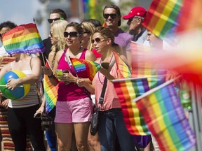 Revellers take part in the Ottawa Pride Parade on Bank Street.