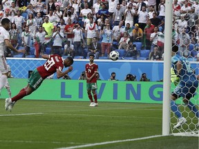 Morocco's Aziz Bouhaddouz, 20, scores an own goal during the Group B match against Iran in St. Petersburg on Friday.