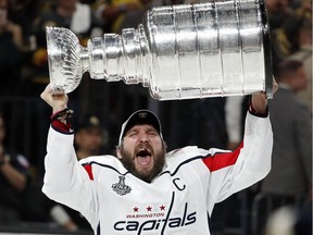 Capitals captain Alex Ovechkin hoists the Stanley Cup after his team defeated the Golden Knights in Game 5 to claim the franchise's first NHL title on Thursday night.
