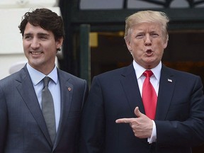 Prime Minister Justin Trudeau is greeted by U.S. President Donald Trump as he arrives at the White House in Washington, D.C., on Oct. 11, 2017.