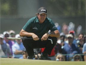 Phil Mickelson lines up a shot on the fourth green during the third round of the U.S. Open on Saturday.