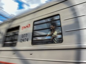 This picture taken on June 20, 2018 shows a fan of the 2018 World Cup tournament riding a train in Saransk, Russia.