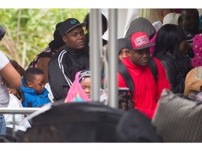 Migrants line up at an illegal border crossing between Canada and the United States. (Geoff Robins/AFP Getty Images)