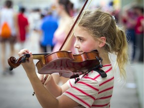 Layla-Bjorn Taherzadeh will celebrate her 10th birthday this week with a little extra money in her pocket after drawing a crowd to her busking performance near Parliament Hill on Canada Day.   Ashley Fraser/Postmedia