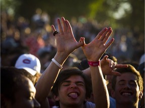 An unidentified young man uses his hands to form a W during the Saturday evening performance of one of the original members of the '90s rap crew the Wu-Tang Clan, Ghostface Killah (aka Tony Starks) at RBC Ottawa Bluesfest.    Ashley Fraser/Postmedia