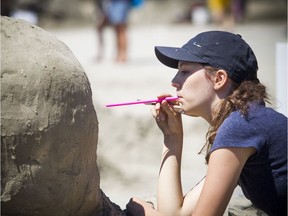 Jasmine Meunier, 13, works on her sand sculpture Saturday, her sixth year taking part in the competition.   Ashley Fraser/Postmedia