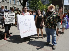 People shout at a protest to changes in Ontario's sex-ed curriculum at the Human Rights Monument in Ottawa on Sunday, July 15, 2018.