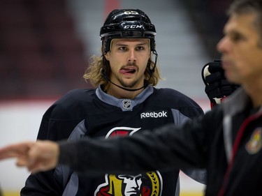 Erik Karlsson listens to assistant coach Dave Cameron as the Ottawa Senators practice at Canadian Tire Centre. Assignment - 118750 // Photo taken at 12:03 on October 23, 2014.