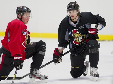 FEBRUARY 21, 2012 -- Daniel Alfredsson and Erik Karlsson stretch as the Ottawa Senators practice at the Kanata Rec Centre, February 21, 2012.
