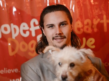 Ottawa Senators captain Erik Karlsson holds one of the dogs attending Hopeful Hearts dog rescue fundraising dinner at Salt restaurant on Preston st. on Sunday, Nov. 2, 2014.