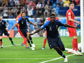 French defender Samuel Umtiti celebrates scoring the game-winning goal against Belgium on Tuesday. (GETTY IMAGES)