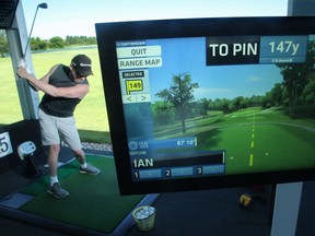 Golfer Ian MacLeod hits a bucket of balls at the  Kevin Haime Golf Centre in Kanata, which has just installed TopTracer. Julie Oliver/Postmedia