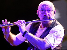 Jethro Tull's Ian Anderson plays against a psychedelic backdrop of old TV footage on the main stage at RBC Ottawa Bluesfest on Friday night.  Julie Oliver/Postmedia