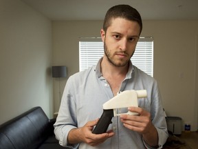 In this May 10, 2013, file photo, Cody Wilson, founder of Defense Distributed, shows a plastic handgun made on a 3D-printer at his home in Austin, Texas. Eight states filed suit Monday, July 30, 2018, against the Trump administration over its decision to allow a Texas company to publish downloadable blueprints for a 3D-printed gun, contending the hard-to-trace plastic weapons are a boon to terrorists and criminals and threaten public safety. (Jay Janner/Austin American-Statesman via AP)