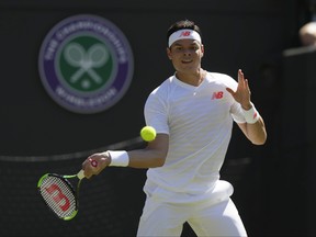 Milos Raonic of Canada returns a ball to Liam Broady of Britain during the Men's Singles first round match at the Wimbledon Tennis Championships in London, Monday July 2, 2018. (AP Photo/Kirsty Wigglesworth)
