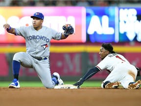 Ozzie Albies #1 of the Atlanta Braves steals second base during the sixth inning against Aledmys Diaz #1 of the Toronto Blue Jays at SunTrust Park on June 26, 2018 in Atlanta, Georgia.