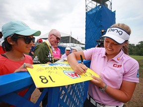 Brooke Henderson of Smiths Falls signs autographs after the third round of the Marathon Classic at Sylvania, Ohio, on Saturday.