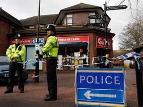 Police officers stand on duty at a cordon near a bench covered in a protective tent at The Maltings shopping centre in Salisbury, southern England, on March 12, 2018, where Ex-Russian spy Sergei Skripal and his daughter Yulia were found critically ill on March 4, after being apparently poisoned with what was later identified as a nerve agent sparking a major incident. (Adrian Dennis/Getty Images)