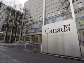 A Government of Canada sign sits in front of a Library and Archives Canada building
