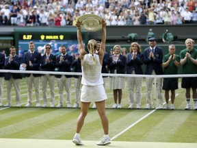 Angelique Kerber holds aloft the trophy after defeating Serena Williams in the women's singles final at Wimbledon on Saturday.