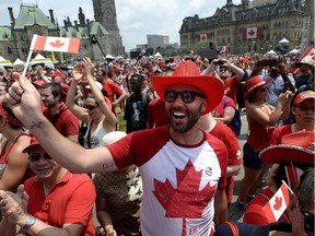 People cheer during Canada Day celebrations on Parliament Hill in Ottawa on Sunday, July 1, 2018.