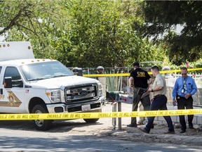 San Bernardino County Sheriff's personnel investigate the scene of a fatal shooting on Friday in Muscoy, Calif. Watchara Phomicinda/The Orange County Register