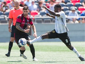 Chris Manella of Ottawa Fury FC, left, defends against Neco Brett (9) of Pittsburgh Riverhounds.