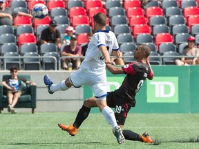 Kyle Venter of Penn FC, left, plays the ball away from Tony Taylor (99) of Fury FC during Saturday's match at TD Place stadium. Steve Kingsman/Freestyle Photography for Ottawa Fury FC