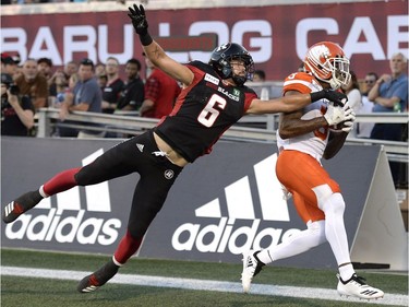 Lions receiver Ricky Collins Jr. avoids the reach of Redblacks safety Antoine Pruneau to make a touchdown catch during first-half action on Friday night.