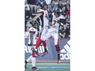 Redblacks fullback Jean-Christophe Beaulieu, left, celebrates with quarterback Trevor Harris after scoring a touchdown against the Alouettes during first-half action on Friday night.
