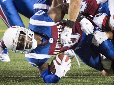 Montreal kick returner Stefan Logan is brought down by Redblacks tacklers late in the second half.